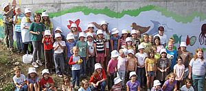 Children in front of a colourful wall