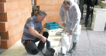 Construction site, men mixing mortar